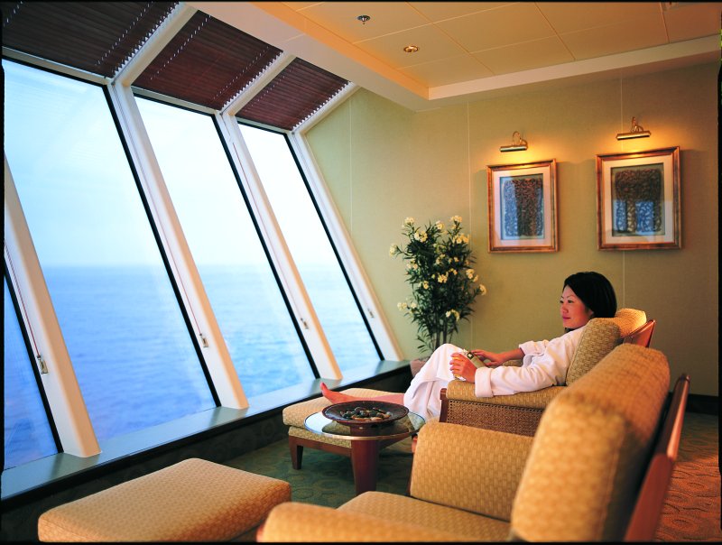 Woman relaxing with a book in the spa
